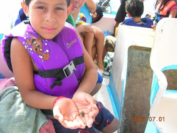 child holding a hermit crab at guayabitos trip