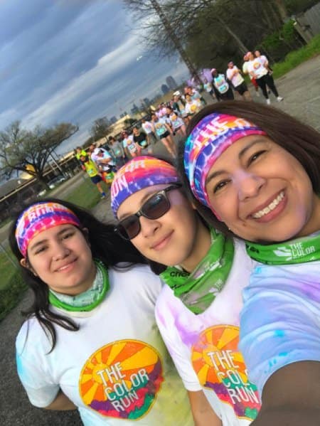 The Color Run runners with the Dallas landscape in the background 